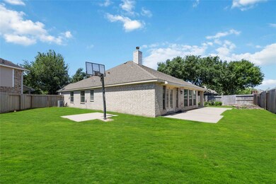 This photo shows a spacious backyard with a well-m