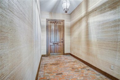 The entry is spectacular with high ceilings, brick