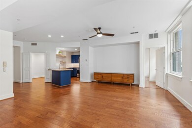 Unfurnished living room featuring ceiling fan, sin
