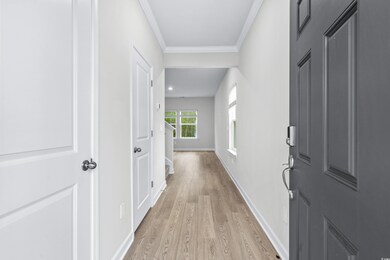 Hallway with light hardwood / wood-style flooring 