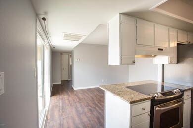 Kitchen opens to another living space