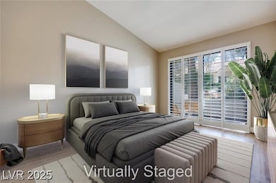Bedroom with wood finished floors, lofted ceiling,