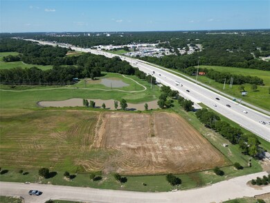 Aerial overview of property's location with a major roadway and a large body of water