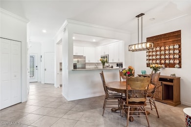 Dining space with light tile patterned flooring, c