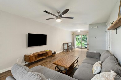 Living area with a ceiling fan and wood finished 