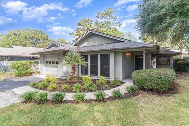 View of front facade with a garage and a front law