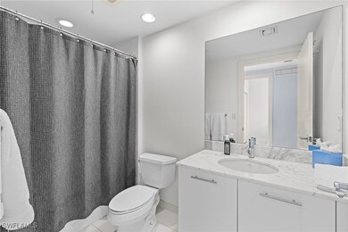 Full bathroom with toilet, vanity, recessed lighting, a shower with shower curtain, and tile patterned flooring