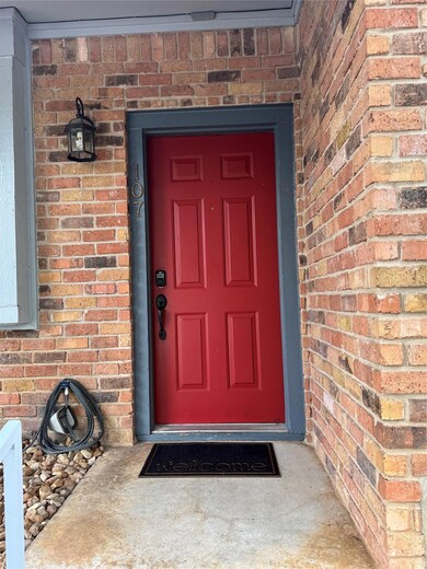 View of exterior entry with brick siding