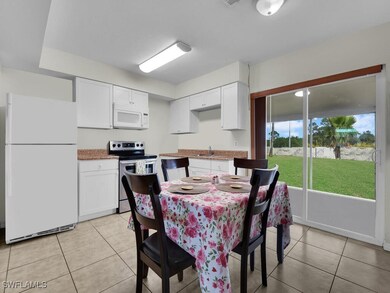Dining space featuring sink and light tile pattern