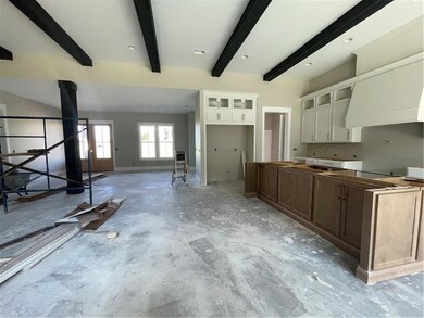 Kitchen featuring beamed ceiling, glass insert cab