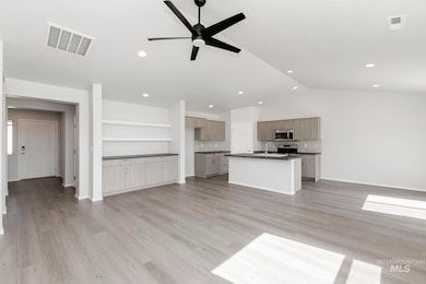 Unfurnished living room featuring light wood-style floors, ceiling fan, lofted ceiling, and recessed lighting