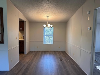 Unfurnished dining area with dark wood-type floor