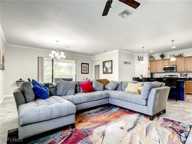 Living room with visible vents, ornamental molding