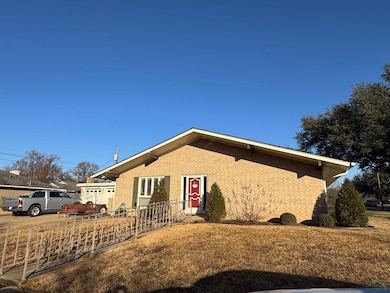 Single story home with brick siding, fence, and a 