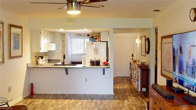 Kitchen featuring white cabinetry, a kitchen break