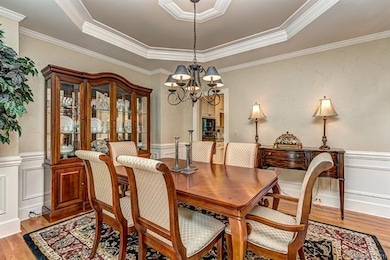 Dining room has heavy millwork and trey ceiling