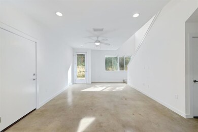 Unfurnished living room featuring concrete floors