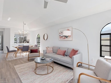 Living room featuring vaulted ceiling, hardwood / 