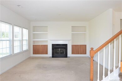 Family room with built in cabinets & book cases.  