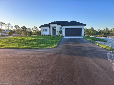 View of front facade featuring driveway, an attach