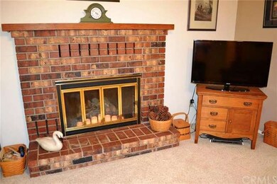 The brick hearth fireplace has a gas log lighter.