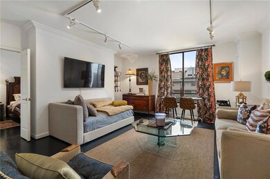 Living room featuring wood finished floors, orname