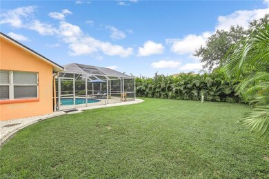 View of green lawn with a sunroom, an outdoor pool, glass enclosure, and a patio