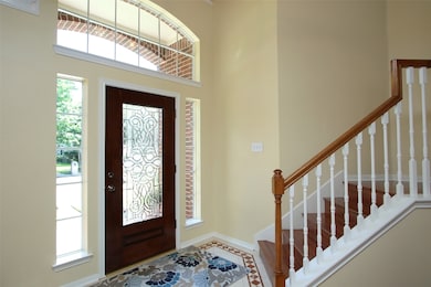 Interior entry has custom tile flooring which transitions into engineered hardwood flooring throughout first floor.