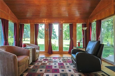 All-season Sun Room with hardwood floors and vault