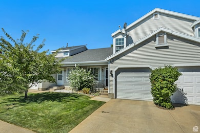 Traditional-style home with driveway, a front lawn, and roof with shingles