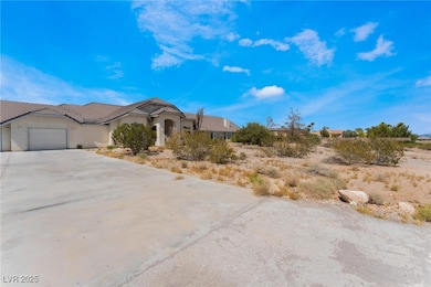 View of front of property featuring a garage, driv
