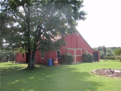 48x36 (6-Stall) Barn w/Wash Bay & Tack Room. Hay in Loft was cut off 2 Acres @ Entrance...$700 to stay. Round Pen to the Left of Barn, and Green House to the Right.