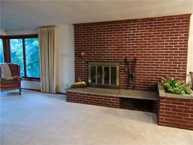 A brick planter box extends from fireplace wall. P