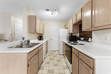 Kitchen featuring sink, light brown cabinetry, whi