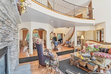 Living room with arched walkways, a towering ceili