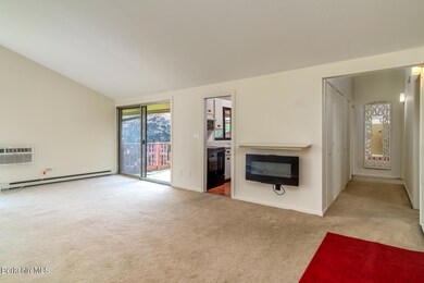 Living room to deck, kitchen and hallway