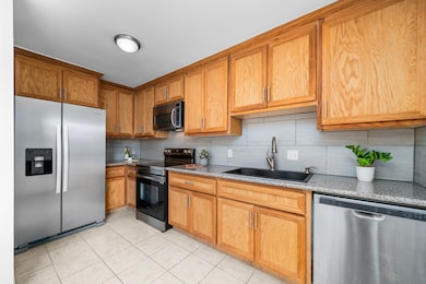 The kitchen offers granite countertops, tile backs