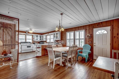 Tiled dining room featuring ceiling fan with notab