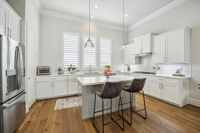 The open, spacious kitchen has center island with