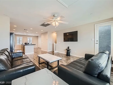 Living room with light wood finished floors, a cei