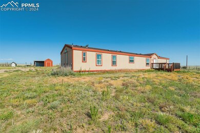 Rear view of house with an outdoor structure and a