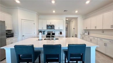 Kitchen with stainless steel appliances, a center 
