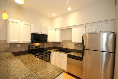 Kitchen features stainless appliances and granite 