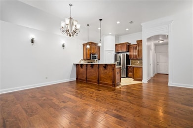 Kitchen with stainless steel appliances, brown cab