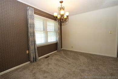 Dining area with updated lighting.
