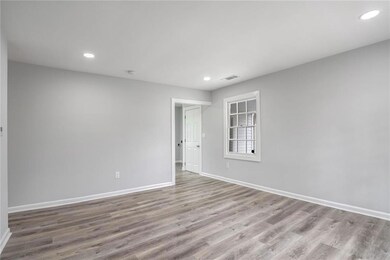 Unfurnished room featuring baseboards, wood finished floors, and recessed lighting