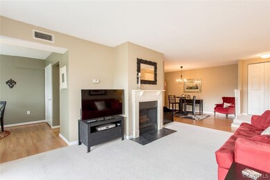 View of living room with wood burning fireplace.