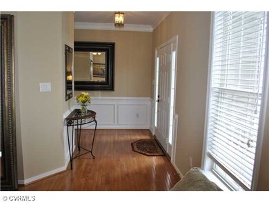 Foyer - Hardwood floor, crown molding, wainscoting