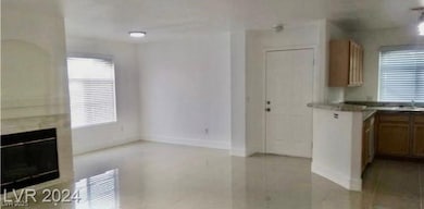 Kitchen with a glass covered fireplace and brown cabinets