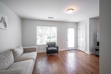 Living area with wood finished floors and baseboards